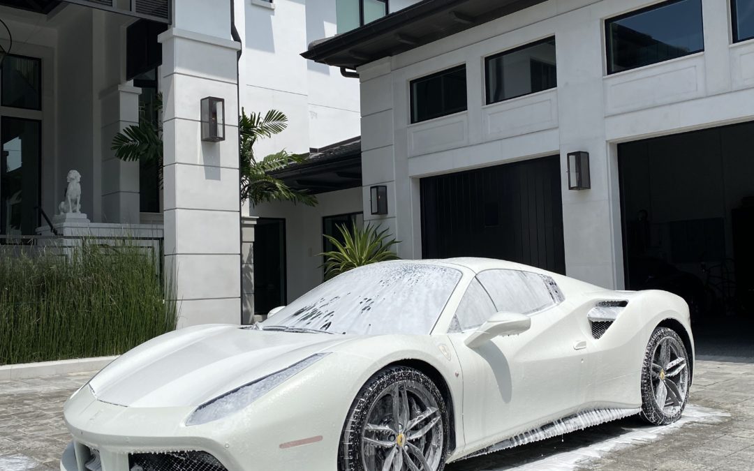 white car being detailed in driveway