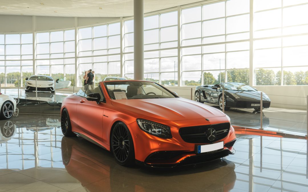 orange car in auto dealership