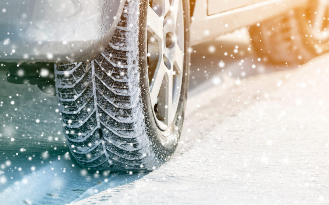 Close-up of car wheels rubber tires in deep winter snow. Transportation and safety concept.