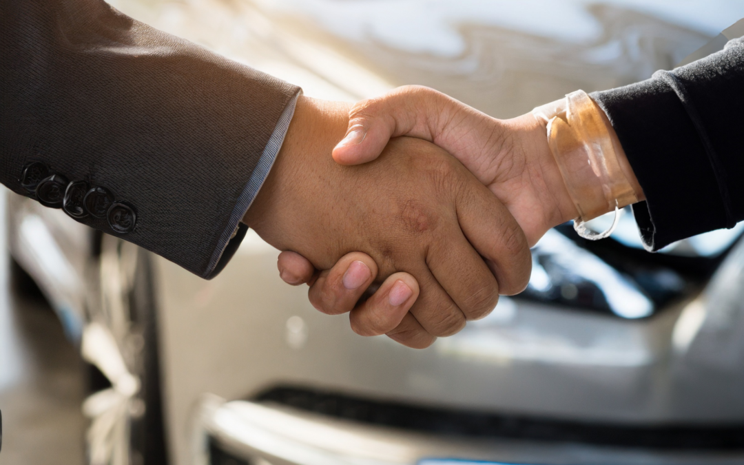 Handshake in front of clean car